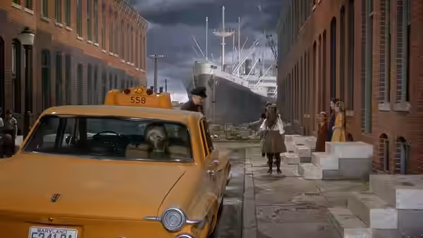 A woman walks along a city sidewalk past a yellow taxi and a docked ship