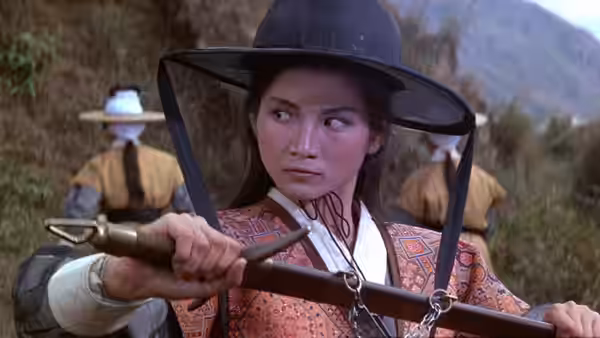 Golden Sparrow (Cheng Pei-pei) rides with reins in hand, glancing to the side
