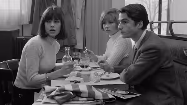 Madeleine Zimmer (Chantal Goya) and Paul (Jean-Pierre Léaud) sit at a restaurant table with another woman