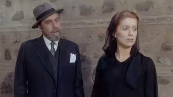 Don Lope (Fernando Rey) stands beside Tristana (Catherine Deneuve), who looks away