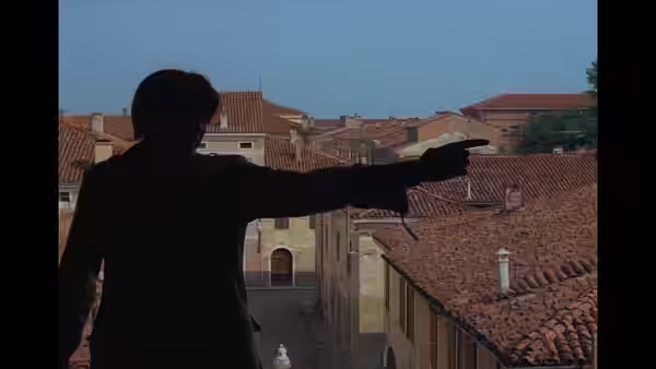A silhouetted figure points across rooftops toward the distant buildings
