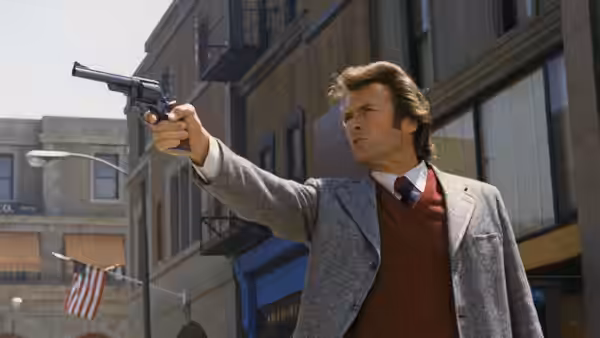 Harry (Clint Eastwood) points his revolver down a downtown street