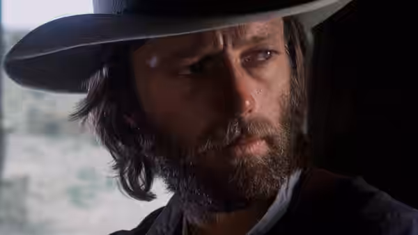 Harry Collings (Peter Fonda) looks ahead beneath the brim of his hat