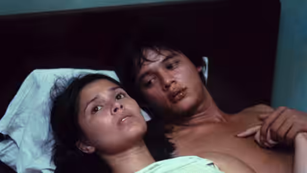 Julio Madiaga (Bembol Roco) lies beside Ligaya Paraiso (Hilda Koronel) in bed