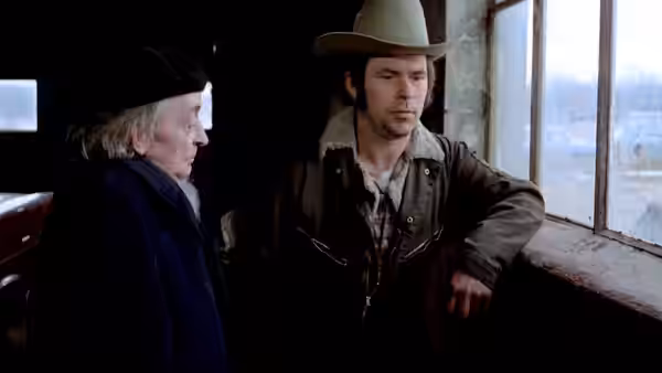 Bruno Stroszek (Bruno Schleinstein) and Scheitz (Clemens Scheitz) stand together beside a train window