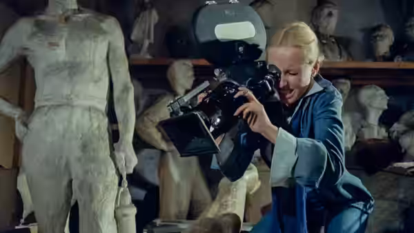 Agnieszka (Krystyna Janda) films among plaster statues in a sculpture studio