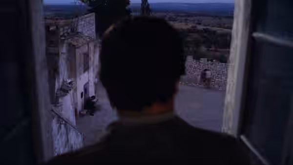 A man looks through a doorway toward a stone courtyard and countryside