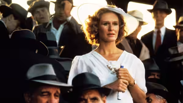 Iris Gaines (Glenn Close) stands among baseball spectators, holding a ticket
