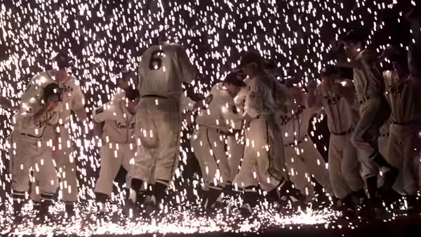 Baseball players gather beneath a shower of fireworks on the field