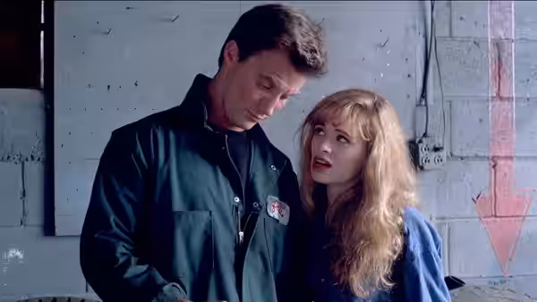Josh (Robert John Burke) looks down as Audry (Adrienne Shelly) speaks beside him