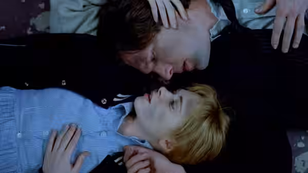 Matthew Slaughter (Martin Donovan) leans over Maria Coughlin (Adrienne Shelly) as she lies on the ground