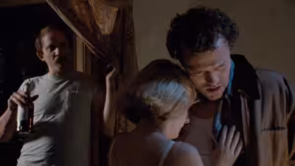 Henry (Michael Rooker) leans close to Becky (Tracy Arnold) while Otis watches from the doorway