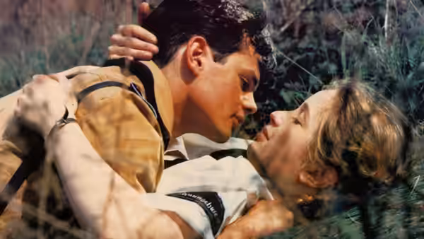 Salomon Perel (Marco Hofschneider) embraces and kisses Leni (Julie Delpy) in the grass
