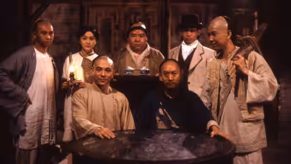 A group gathers around a table inside a traditional wooden room