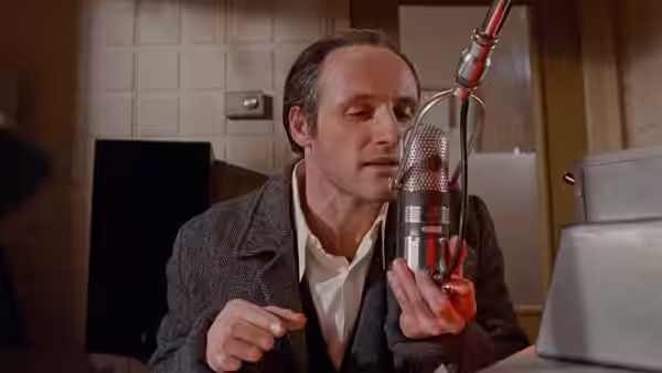 Glenn Gould (Colm Feore) leans toward a studio microphone while recording