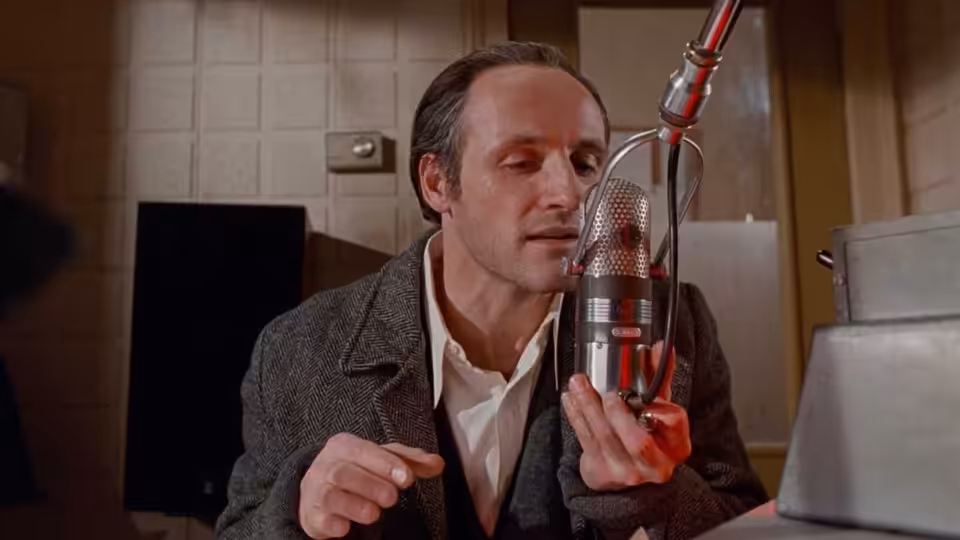 Glenn Gould (Colm Feore) leans toward a studio microphone while recording
