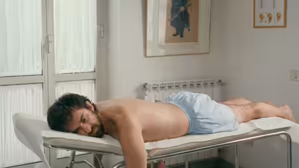 Nanni Moretti (Nanni Moretti) lies face down on an examination table