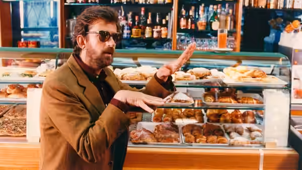 Nanni Moretti (Nanni Moretti) gestures beside a pastry counter