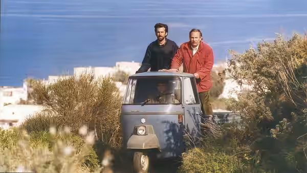 Nanni Moretti (Nanni Moretti) and Gerardo (Renato Carpentieri) ride standing in a small three-wheeled vehicle