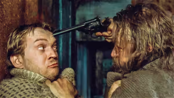 A long-haired man presses a pistol to another man's forehead inside a cabin