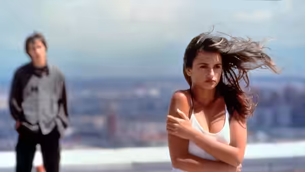 Sofía (Penélope Cruz) stands on a rooftop as César watches behind her