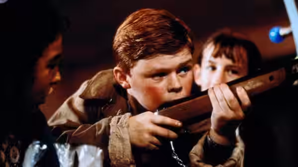 Francie Brady (Eamonn Owens) aims a rifle as another boy watches