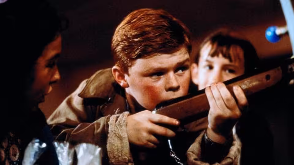 Francie Brady (Eamonn Owens) aims a rifle as another boy watches