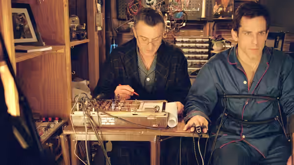 Jack operates a polygraph while Greg sits wired in his basement