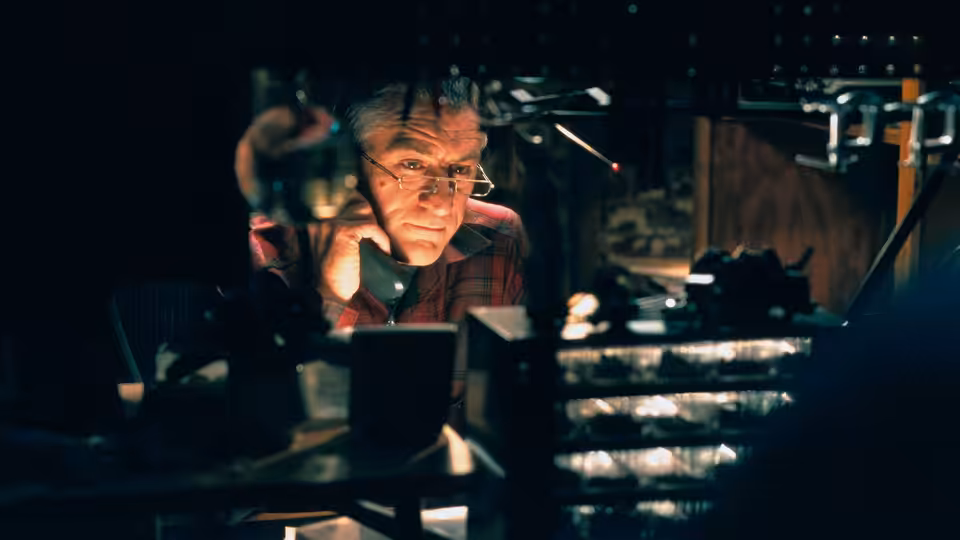 Jack watches from behind the polygraph equipment in his basement