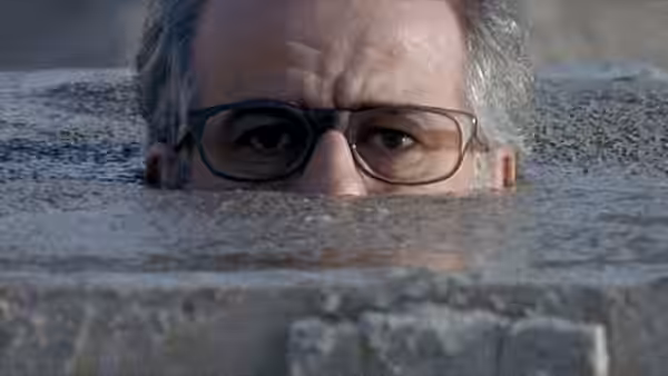 Titta Di Girolamo (Toni Servillo) peers above the water in a swimming pool