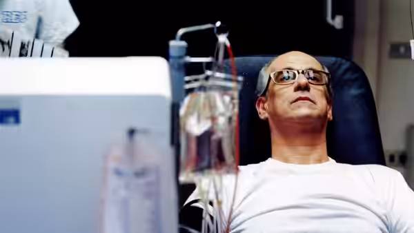 Titta Di Girolamo (Toni Servillo) reclines in a hospital chair beside an intravenous drip