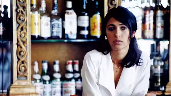 Sofia (Olivia Magnani) stands behind a bar lined with bottles