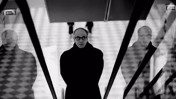 Titta Di Girolamo (Toni Servillo) stands alone in a mirrored elevator