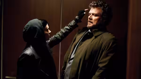 Lisbeth Salander (Rooney Mara) presses a gun to Martin Vanger (Stellan Skarsgård)'s head