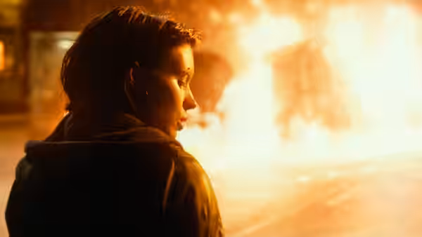 Lisbeth Salander (Rooney Mara) watches a blaze from nearby