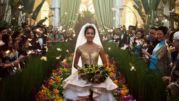 Araminta Lee (Sonoya Mizuno) walks down a flower-lined wedding aisle