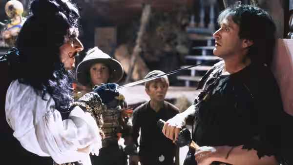 Captain Hook (Dustin Hoffman) confronts Peter Banning (Robin Williams) with sword drawn as two boys watch