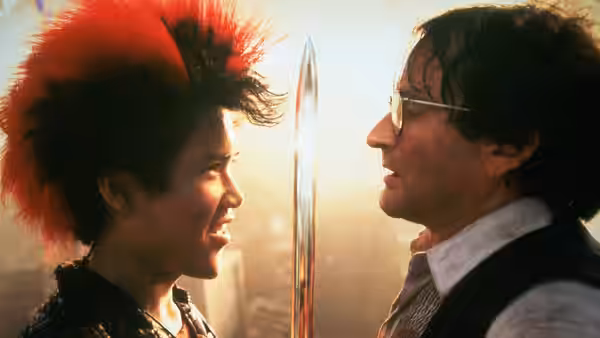 Peter Banning (Robin Williams) faces a red-haired youth with a sword between them