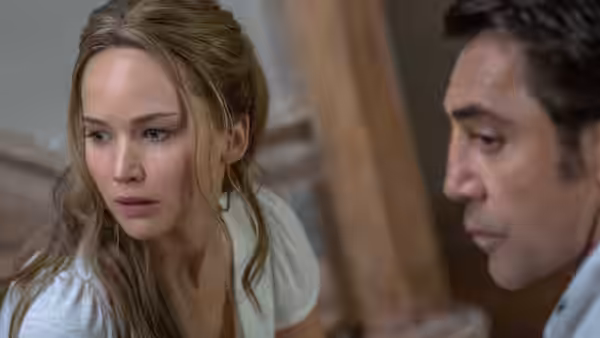 Mother (Jennifer Lawrence) and Him (Javier Bardem) look offscreen inside the house