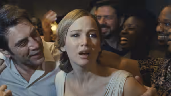Mother (Jennifer Lawrence) looks distressed as party guests crowd around her
