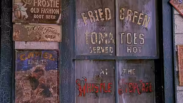 Painted signs advertising fried green tomatoes on wooden doors