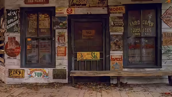 Boarded up cafe entrance covered with vintage advertisements