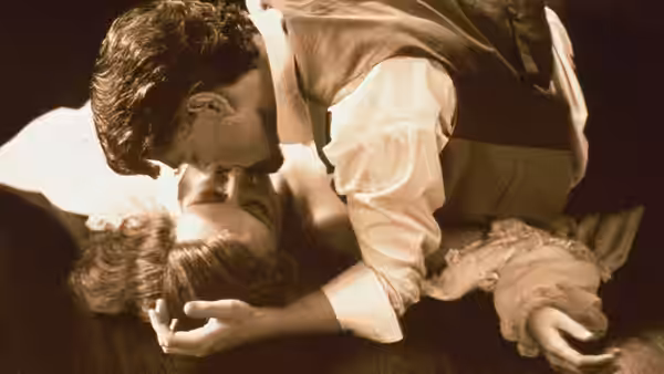 Roman Strauss (Kenneth Branagh) leaning over Margaret Strauss (Emma Thompson) on the floor