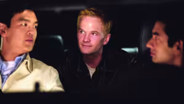 Neil Patrick Harris sits between Harold and Kumar in a car
