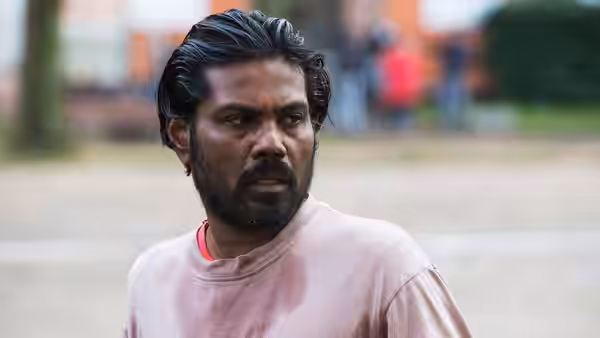 Dheepan (Antonythasan Jesuthasan) turns to look over his shoulder outdoors