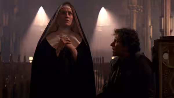 The Nun (Frankie Thorn) standing while LT (Harvey Keitel) kneels nearby in church