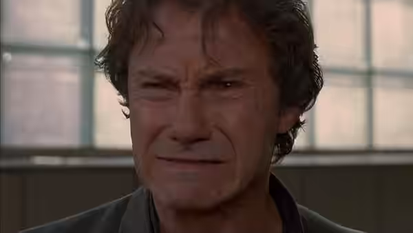 LT (Harvey Keitel) grimacing with eyes squeezed shut in close-up