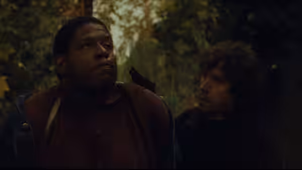 Jody (Forest Whitaker) with gun to his head by Fergus (Stephen Rea) among trees