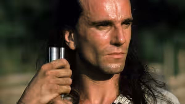 Hawkeye (Daniel Day-Lewis) holding a small metal cylinder in close-up