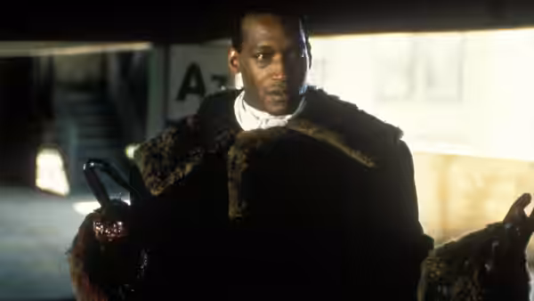 Candyman (Tony Todd) standing with hook in hand inside an empty garage